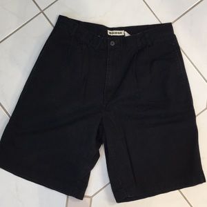 Black pleated cotton shorts.